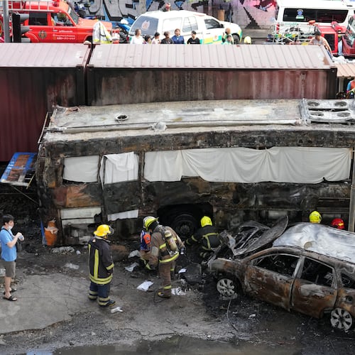 Rescuers work at a train crash site near an airport rail link station in Bangkok, Thailand, Saturday, May 16, 2026. (AP Photo/Sakchai Lalit)