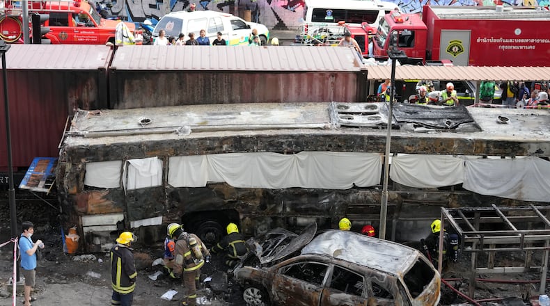 Rescuers work at a train crash site near an airport rail link station in Bangkok, Thailand, Saturday, May 16, 2026. (AP Photo/Sakchai Lalit)