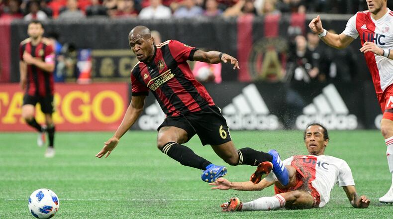 Atlanta United midfielder Darlington Nagbe (6) gets tripped up against the New England Revolution during the first half of an MLS soccer game, Saturday, Oct. 6, 2018. (John Amis)
