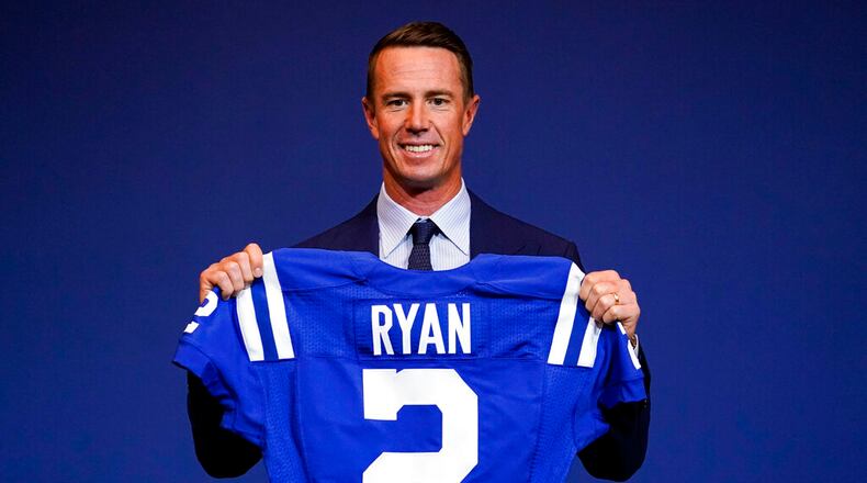 Indianapolis Colts quarterback Matt Ryan holds up his new jersey following a press conference at the NFL team's practice facility in Indianapolis on March 22, 2022. (AP Photo/Michael Conroy, File)