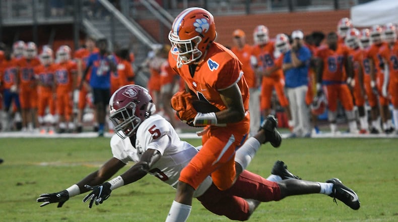 Parkview WR Cj Daniels (4) catches a pass as Lowndes CB Josh Brown defends before taking the ball in for a TD during a high school football game in Lilburn, Friday August 31, 2018. (John Amis/Special)
