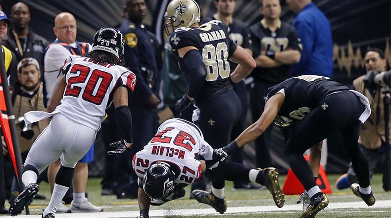 Falcons cornerback Robert McClain (27) intercepts a pass intended for New Orleans Saints wide receiver Nick Toon (right) in Sunday's 30-14 win in New Orelans.