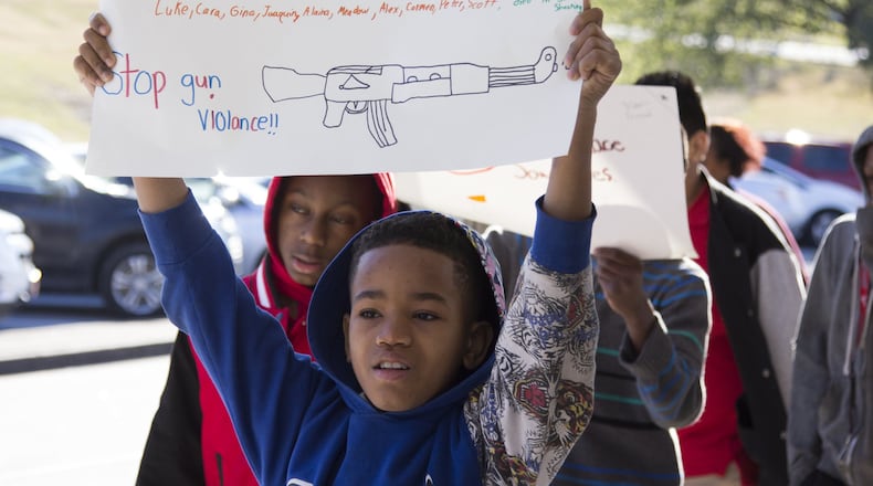 Mundy’s Mill Middle School students hold signs during their walkout in Jonesboro on Wednesday, March 14, 2018. Students across the Metro Atlanta area held walkouts to protest gun violence as part of a nationwide demonstration. REANN HUBER/REANN.HUBER@AJC.COM