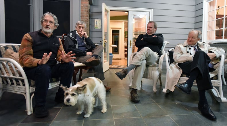 David Godfrey (left) talks as fellow book club members Bob Stewart, Stephen Roberts and Bill Turnipseed listen intently during a discussion of “The Book of Daniel” recently at Roberts’ home in Decatur. HYOSUB SHIN / HSHIN@AJC.COM