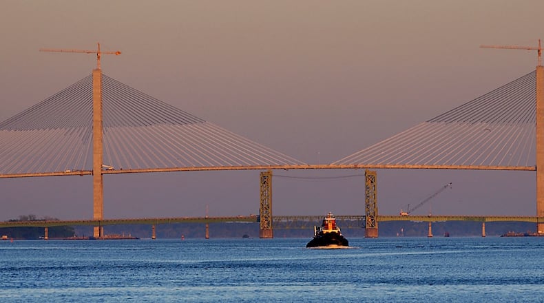 In this 2003 photo, a tugboat makes it's way to Colonel's Island to help take a cargo ship out to sea. In the background are the new and old Sidney Lanier bridges. The newest one spans the width of this photo, and is the largest bridge in Georgia, and one of the largest cable-stayed bridges in the world. The bridge will be dedicated April 7 after seven years of construction and a two-year delay in completion. (JOEY IVANSCO/AJC staff)