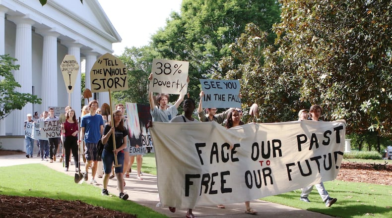 Current and former University of Georgia students, faculty and community activists march toward Baldwin Hall on May 6, 2019, on the University of Georgia campus in Athens. The demonstrators have pushed the school to offer various forms of reparations to address how, they say, the university has taken advantage of descendants of enslaved peoples, pay a higher working wage for university employees and give justice to the slaves who were found buried below Baldwin Hall.