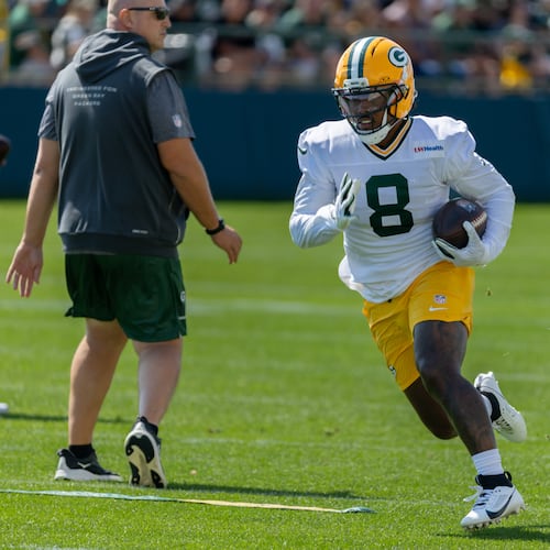 Green Bay Packers running back Josh Jacobs (8) runs with the ball during a drill at the NFL football team's training camp, Sunday, Aug. 2, 2026, in Green Bay, Wis. (AP Photo/Mike Roemer)