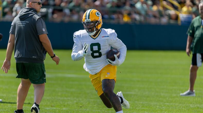 Green Bay Packers running back Josh Jacobs (8) runs with the ball during a drill at the NFL football team's training camp, Sunday, Aug. 2, 2026, in Green Bay, Wis. (AP Photo/Mike Roemer)