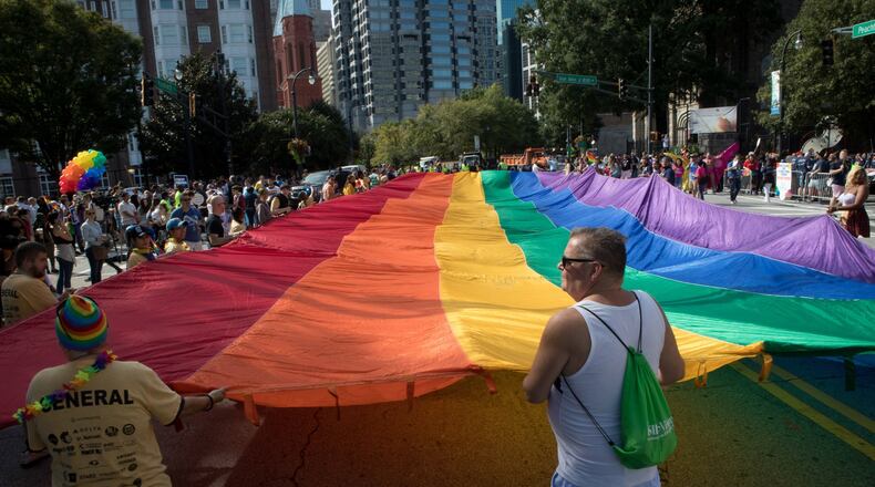 A giant rainbow flag makes its way down Peachtree Street during the Atlanta Pride Parade Sunday in Atlanta October 14, 2018. Photo: STEVE SCHAEFER / SPECIAL TO THE AJC