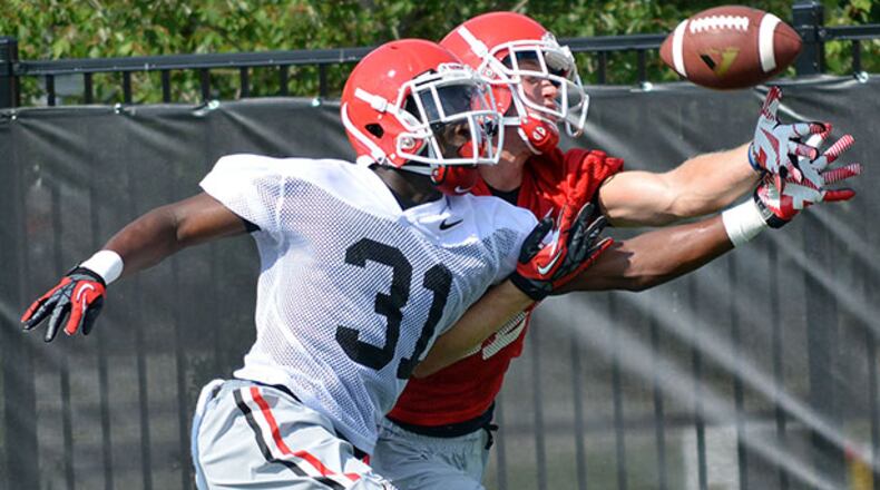 Receiver Michael Bennett is covered by defensive back Shattle Fenteng (31) during Georgia practice.