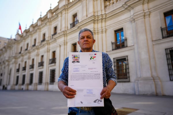 Fredy Maureira, the father of Valentina, who suffered from cystic fibrosis and died at the age of 14, holds a copy of a letter he left at the presidential palace requesting a meeting with President Gabriel Boric, in Santiago, Chile, Monday, March 24, 2025. (AP Photo/Esteban Felix)