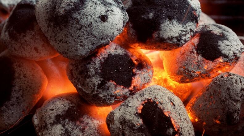 According to Debbie Moose, there's nothing like grilling over real charcoal.   (Chris Seward/Raleigh News & Observer/TNS)