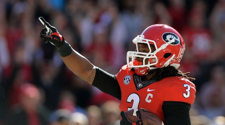 Georgia running back Todd Gurley (3) celebrates his first touchdown of the game against Vanderbilt at Sanford Stadium in Athens Saturday October 4, 2014. He will meet with teams at the combine and undergo medical tests. BRANT SANDERLIN / BSANDERLIN@AJC.COM