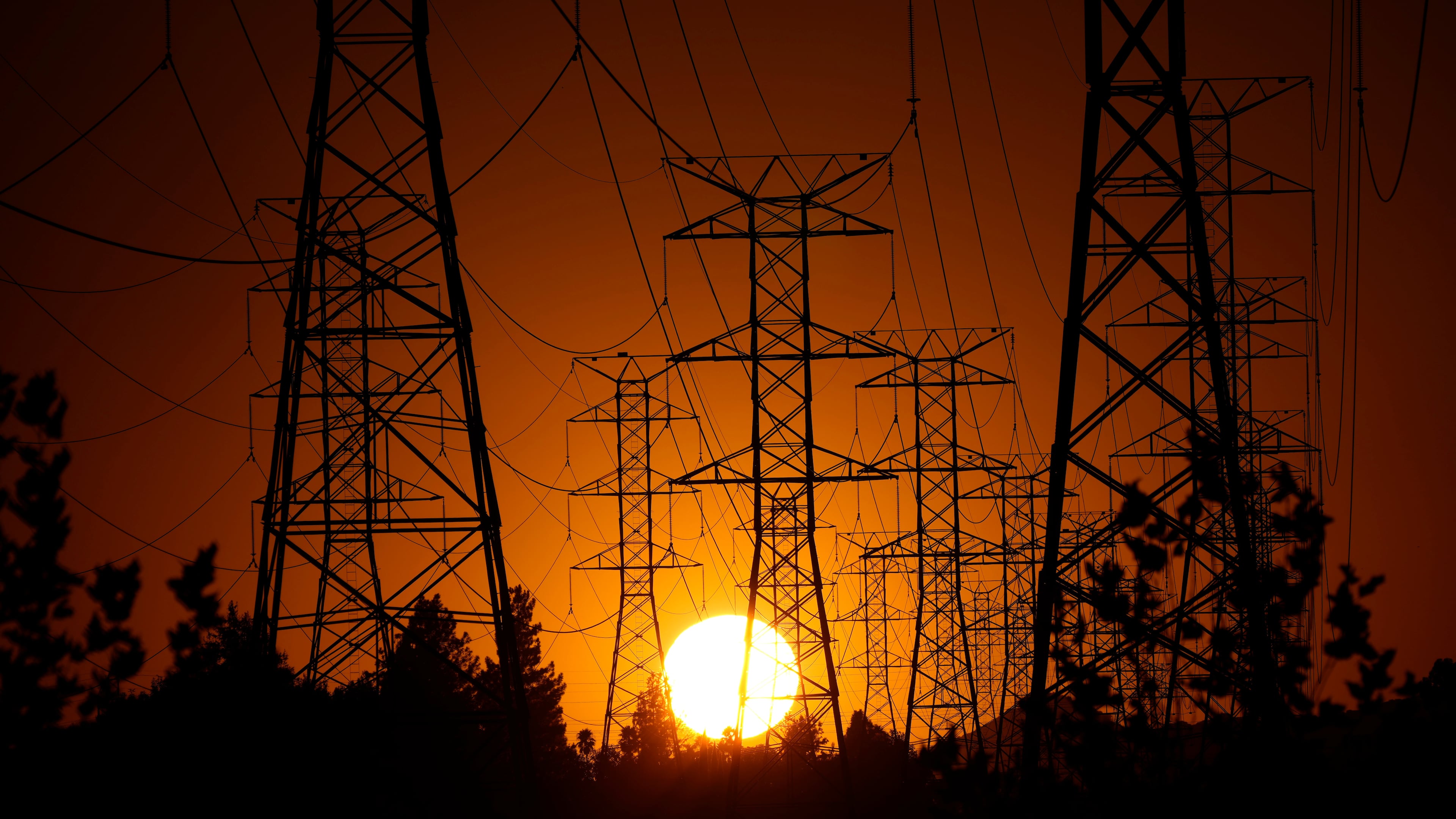 FILE - The sun sets behind high tension power lines, Monday, Sept. 23, 2024, in the Porter Ranch section of Los Angeles. (AP Photo/Mark J. Terrill, File)
