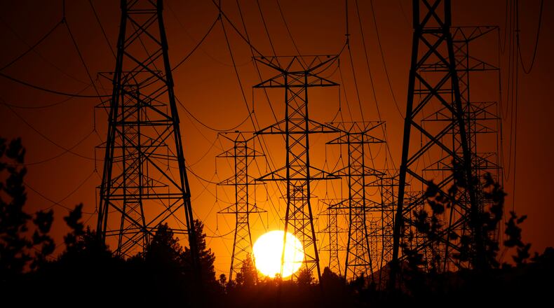 FILE - The sun sets behind high tension power lines, Monday, Sept. 23, 2024, in the Porter Ranch section of Los Angeles. (AP Photo/Mark J. Terrill, File)