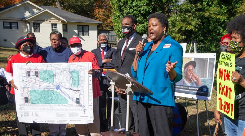 Councilman Andre Dickens (center) listens as City Council President Felicia Moore speaks during an rally in support of Peoplestown residents who are locked in a legal battle with the city of Atlanta's over their attempts to stay in their homes. PHIL SKINNER FOR THE ATANTA JOURNAL-CONSTITUTION