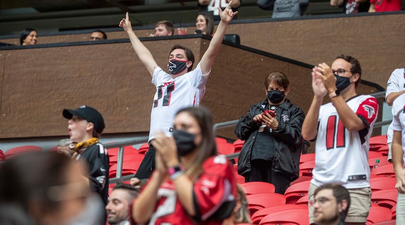 Falcons fans celebrate a touchdown against the Denver Broncos at Mercedes-Benz Stadium on November 8, 2020. (Photo by Alyssa Pointer/AJC)