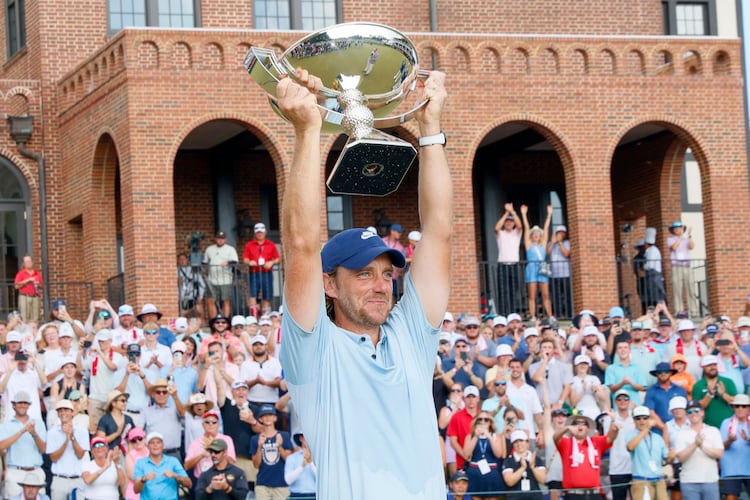 Tommy Fleetwood, of England, lifts the PGA Tour Championship trophy at East Lake Golf Club on Sunday, Aug. 24, 2025, in Atlanta. (Miguel Martinez/ AJC)
