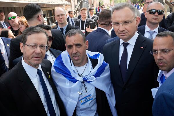 Poland's President Andrzej Duda, right, and his Israel's counterpart Isaac Herzog arrive at the former Nazi German death camp of Auschwitz-Birkenau to attend the "March of the Living", the annual Holocaust remembrance event in memory of the six million Holocaust victims in Oswiecim, Poland, Thursday, April 24, 2025. (AP Photo/Czarek Sokolowski)