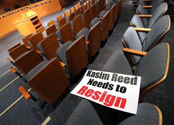 February 28, 2017, Lawrenceville: Signs have been set out calling for Atlanta Mayor Kasim Reed to resign at the Gwinnett County Board of Commissioners public hearing session before it begins on Tuesday Feb. 28, 2017, in Lawrenceville. Atlanta Mayor Kasim Reed contacted United Consulting, a city vendor that also employs embattled Gwinnett County Commissioner Tommy Hunter. Reed sent a threatening letter to the Norcross-based engineering firm, denouncing the content of Hunters now infamous Jan. 14 Facebook post  in which he called civil rights leader and U.S. Rep. John Lewis a racist pig  asking how the company planned to resolve this matter.    Curtis Compton/ccompton@ajc.com