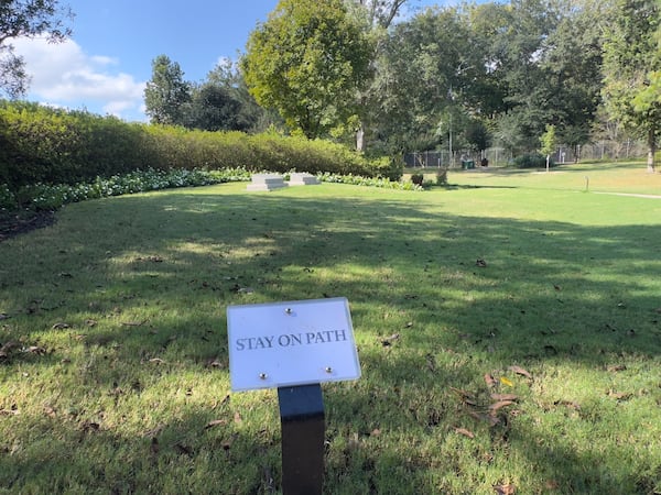 Visitors at Carter Gardens, the burial site for former President Jimmy Carter and former First Lady Rosalynn Carter, are reminded to keep off the grass near the graves. (Joe Kovac Jr./AJC)