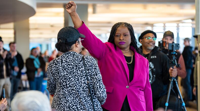FILE - Nekima Levy Armstrong holds up her fist after speaking at an anti-ICE rally for Martin Luther King Jr., Monday, Jan. 19, 2026, in St. Paul, Minn. (AP Photo/Angelina Katsanis, File)