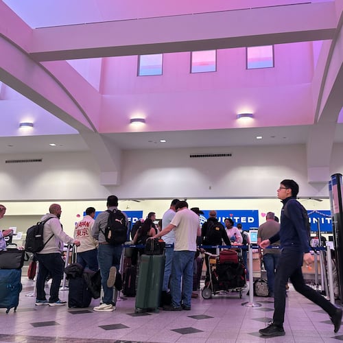 FILE - People stand in line at check-in counters at El Paso International Airport, Wednesday, Feb. 11, 2026, in El Paso, Texas. (AP Photo/Morgan Lee,File)