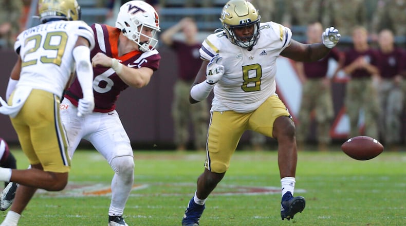 Georgia Tech's Clayton Powell-Lee (29) and Makius Scott (8) chase a fumble by Virginia Tech quarterback Grant Wells (6) late in the second half of an NCAA college football game, Saturday, Nov. 5 2022, in Blacksburg, Va. (Matt Gentry/The Roanoke Times via AP)