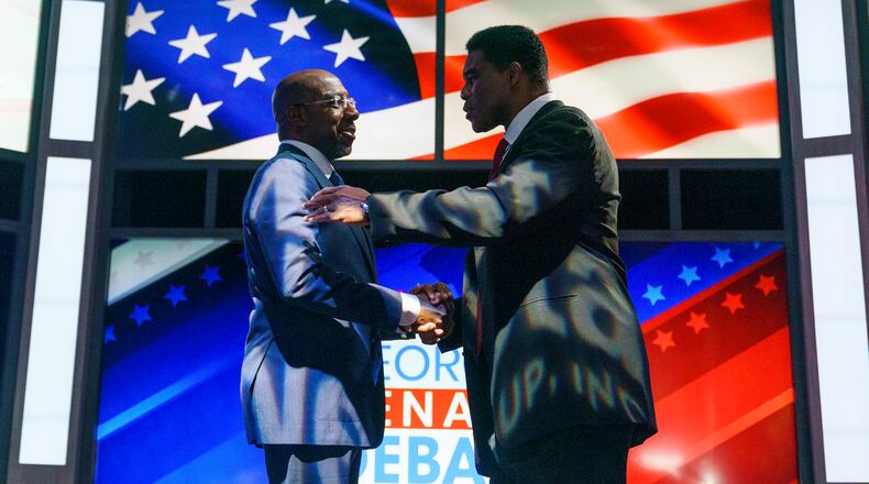 Sen. Raphael Warnock (D-Ga.) shakes hands with Republican candidate Herschel Walker prior to the Nexstar Georgia Senate Debate at District Live at Plant Riverside District in Savannah, Ga., on Friday, October 14, 2022.
