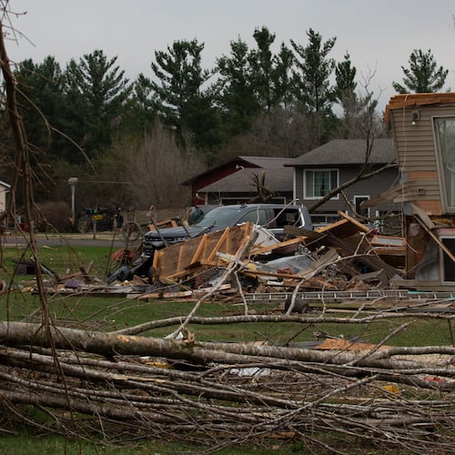 Debris and fallen tree limbs cover the ground after a severe storm that tore through the Upper Midwest on Friday, April 17, 2026, in Rochester, Minn. (Hollie Bennett Piotrowicz via AP)