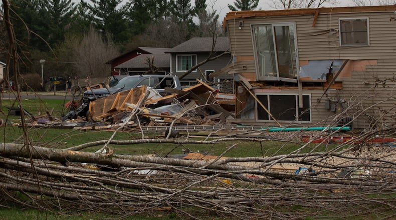 Debris and fallen tree limbs cover the ground after a severe storm that tore through the Upper Midwest on Friday, April 17, 2026, in Rochester, Minn. (Hollie Bennett Piotrowicz via AP)