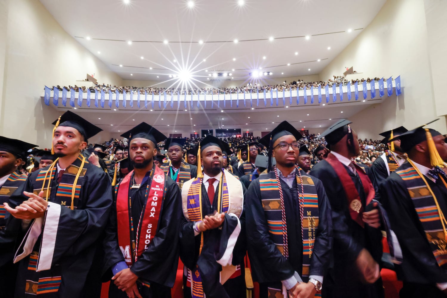 Graduates stand up as they prepare to receive their diplomas during the 141st Commencement Ceremony of Morehouse College on Sunday, May 18, 2025.(Miguel Martinez/ AJC)