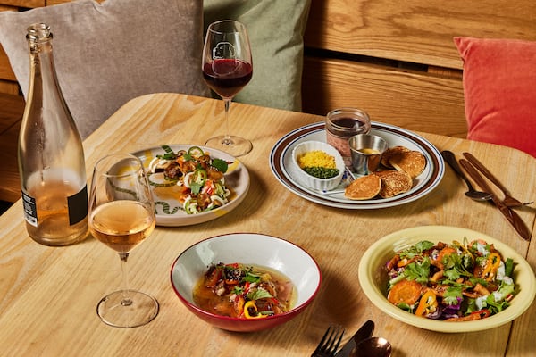 Food items and wine at Little Bear. The team behind Little Bear plan to open a second restaurant, Bar Schmutzi. (Bailey Garrot for the AJC/Styling by Jarrett Stieber)