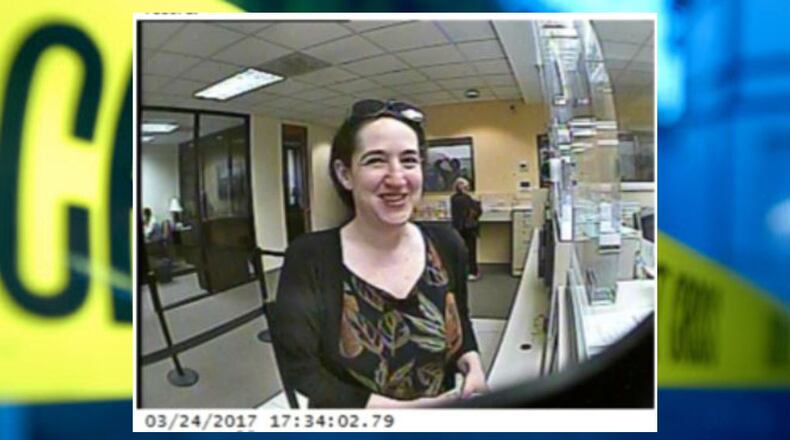 Sandy Springs police were seeking the person in this surveillance photo in connection with a theft from the bank account of PAWS Atlanta. (Credit: Sandy Springs Police Department)