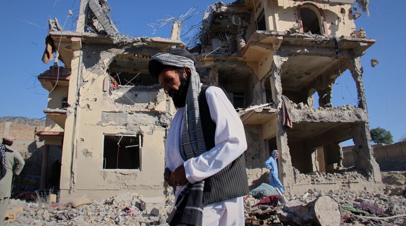 Residents walk through the rubble after what Taliban officials said were Pakistani airstrikes a day earlier that killed civilians, including children, in the village of Mandokhail, Chamkani district, Paktia province, Afghanistan, Monday, June 29, 2026. (AP Photo/Saifullah Zahir)