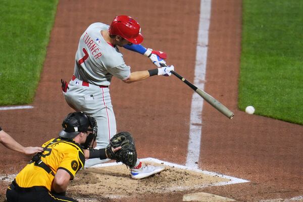 Philadelphia Phillies' Trea Turner (7) singles off Pittsburgh Pirates pitcher Chase Shugart, driving in two runs during the fourth inning of a baseball game in Pittsburgh, Friday, June 6, 2025. (AP Photo/Gene J. Puskar)