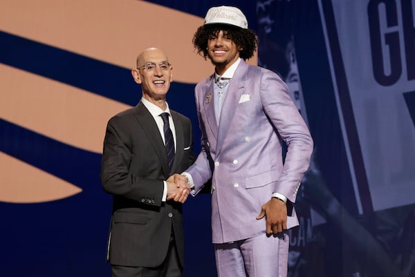 Asa Newell (right) is wearing a Pelicans hat because the trade isn't technically official yet.