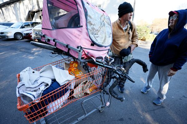 Tracy Thompson, right, director of the nonprofit Elizabeth Foundation, speaks with Mike as he is ready to go visit The Hill, a homeless encampment burned by a brush fire days earlier on Nov. 9. Mike collected items that the Elizabeth Foundation and partners provide, such as food, clothes and cleaning supplies. 
Miguel Martinez / miguel.martinezjimenez@ajc.com
