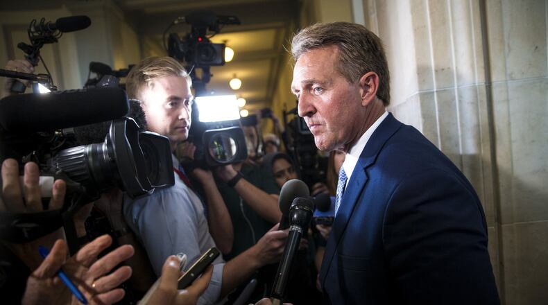 Sen. Jeff Flake (R-Ariz.) speaks with reporters following his announcement he would not be running for re-election in 2018, on Capitol Hill in Washington, Oct. 24, 2017. Flake, who has tangled with President Donald Trump for months, made his announcement from the Senate floor, saying he “will no longer be complicit or silent” in the face of the president’s “reckless, outrageous and undignified” behavior. (Al Drago/The New York Times)