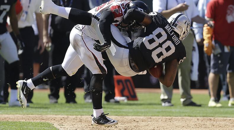 Atlanta Falcons linebacker Sean Weatherspoon (56) tackles Oakland Raiders tight end Clive Walford (88) during the first half in Oakland, Calif., Sunday, Sept. 18, 2016.