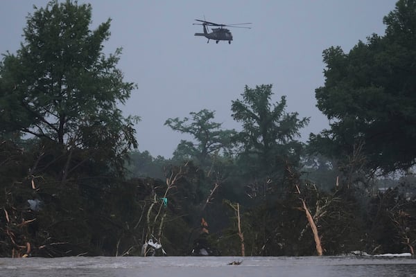 FILE - A helicopter flies over the Guadalupe River after a flash flood swept through the area July 4, 2025, in Kerrville, Texas. (AP Photo/Eric Gay, File)