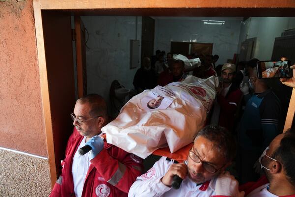 Mourners carry the bodies of 8 Red Crescent emergency responders, recovered in Rafah a week after an Israeli attack, as they are transported for burial from a hospital in Deir al-Balah, Gaza Strip, on Monday, March 31, 2025. (AP Photo/Abdel Kareem Hana)