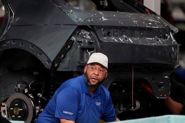 An employee works on the line during a media tour at the Hyundai Motor Group Metaplant America, Wednesday, March 26, 2025, in Ellabell, Ga. (AP Photo/Mike Stewart)
