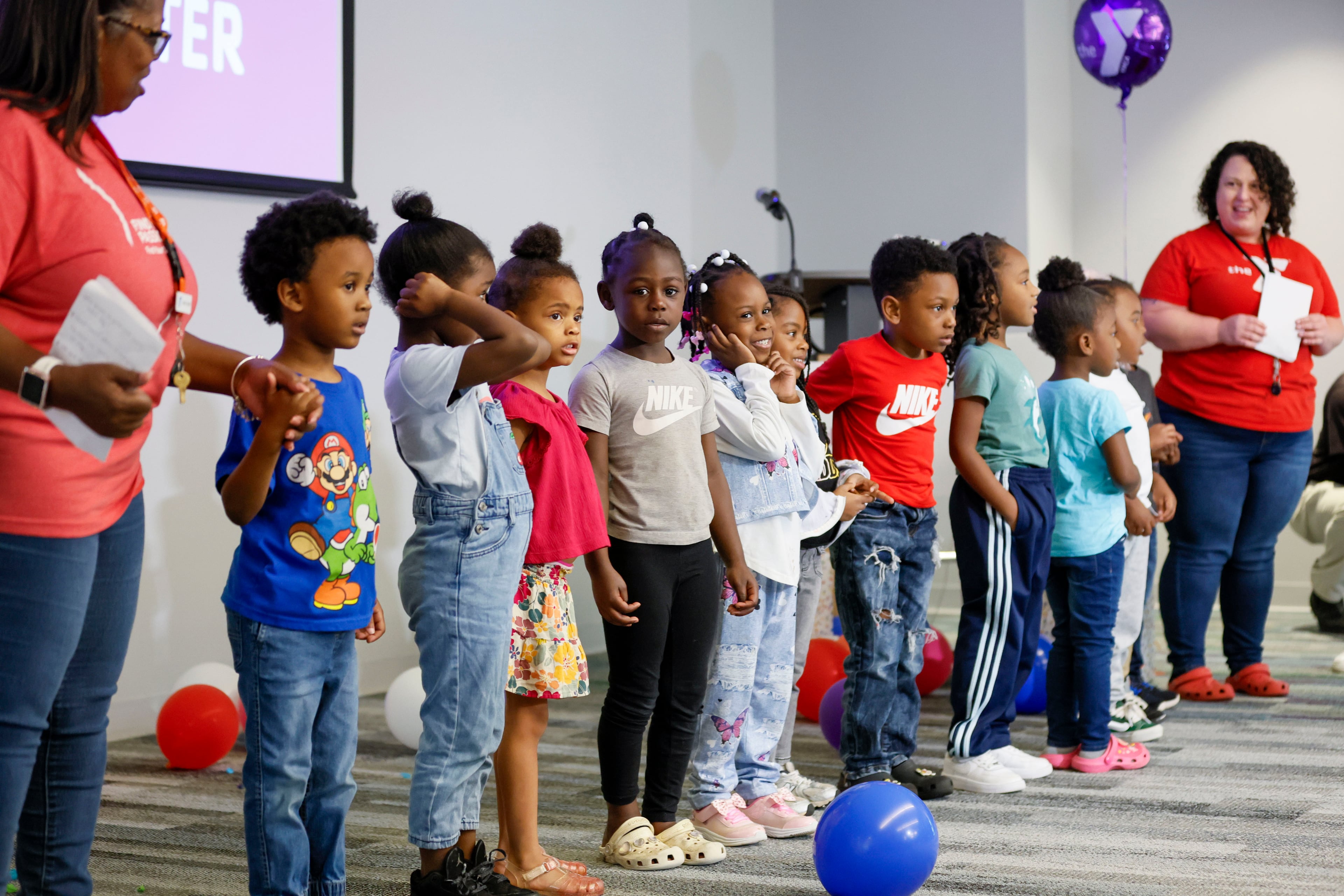 Children in the Head Start program are introduced to singing a couple of songs during a celebration of the federal program's 60th anniversary on Monday. (Miguel Martinez/AJC)
