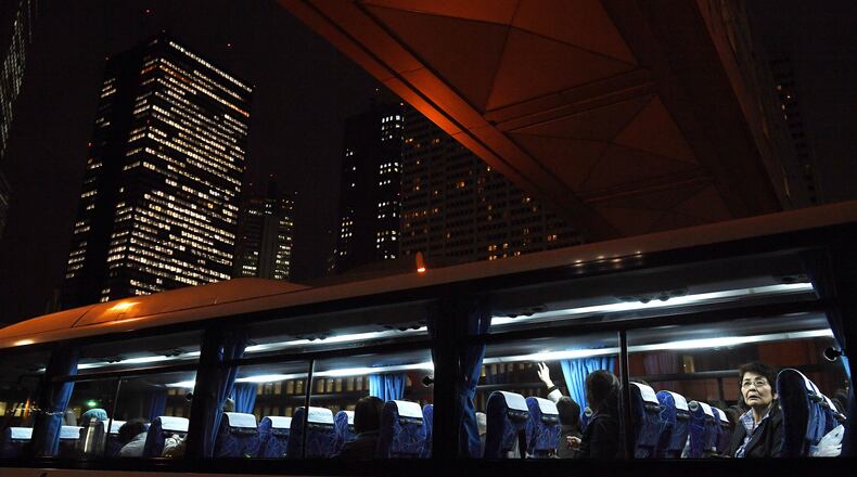 People are seen on a bus on an overcast Friday in Tokyo, Japan. Photo for The Washington Post by Matt McClain.