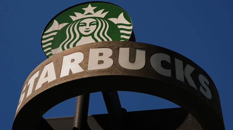 FILE - A Starbucks sign is seen outside the coffee company's global corporate headquarters, May 11, 2026, in Seattle. (AP Photo/Lindsey Wasson, File)