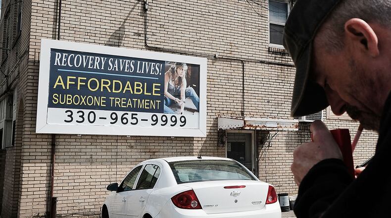 YOUNGSTOWN, OH - JULY 14:  A man walks by a billboard for a drug recovery center in Youngstown on July 14, 2017 in Youngstown, Ohio. Youngstown, a city that was once one of the nation's manufacturing hubs, has been struggling with high unemployment and a surge in opioid addiction.  (Photo by Spencer Platt/Getty Images)