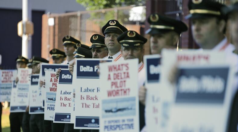 Delta Air Line pilots, represented by the Air Line Pilots Association, picketed at Delta headquarters in September. Contract negotiations took more than 19 months. BOB ANDRES /BANDRES@AJC.COM