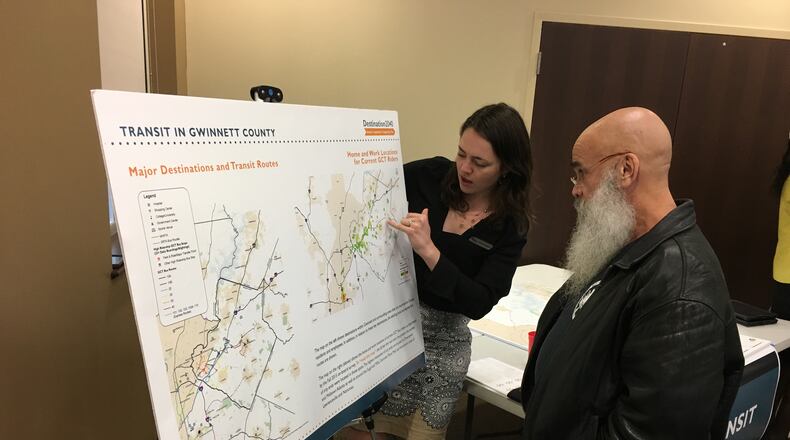 Lawrenceville resident Roy Pozarelli speaks with Maggie Maddox of planning firm VHB during a Monday night meeting at Lilburn City Hall. The meeting was held to discuss Gwinnett County’s comprehensive transportation plan. TYLER ESTEP / TYLER.ESTEP@AJC.COM