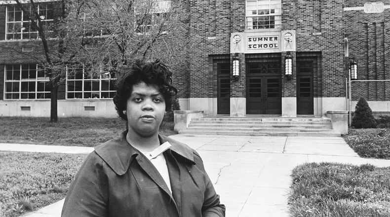 FILE - This May 8, 1964 file photo shows Linda Brown Smith standing in front of the Sumner School in Topeka, Kansas. The refusal of the public school to admit Brown in 1951, when she was 9 years old, led to the Brown v. Board of Education of Topeka, Kansas lawsuit. In 1954, the U.S. Supreme Court mandated that schools nationwide must be desegregated.  (AP Photo, File)